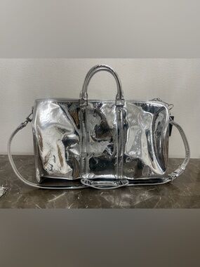 New! Unused! Silver LV Duffle Bag with Zipper closure, inside pocket and strap